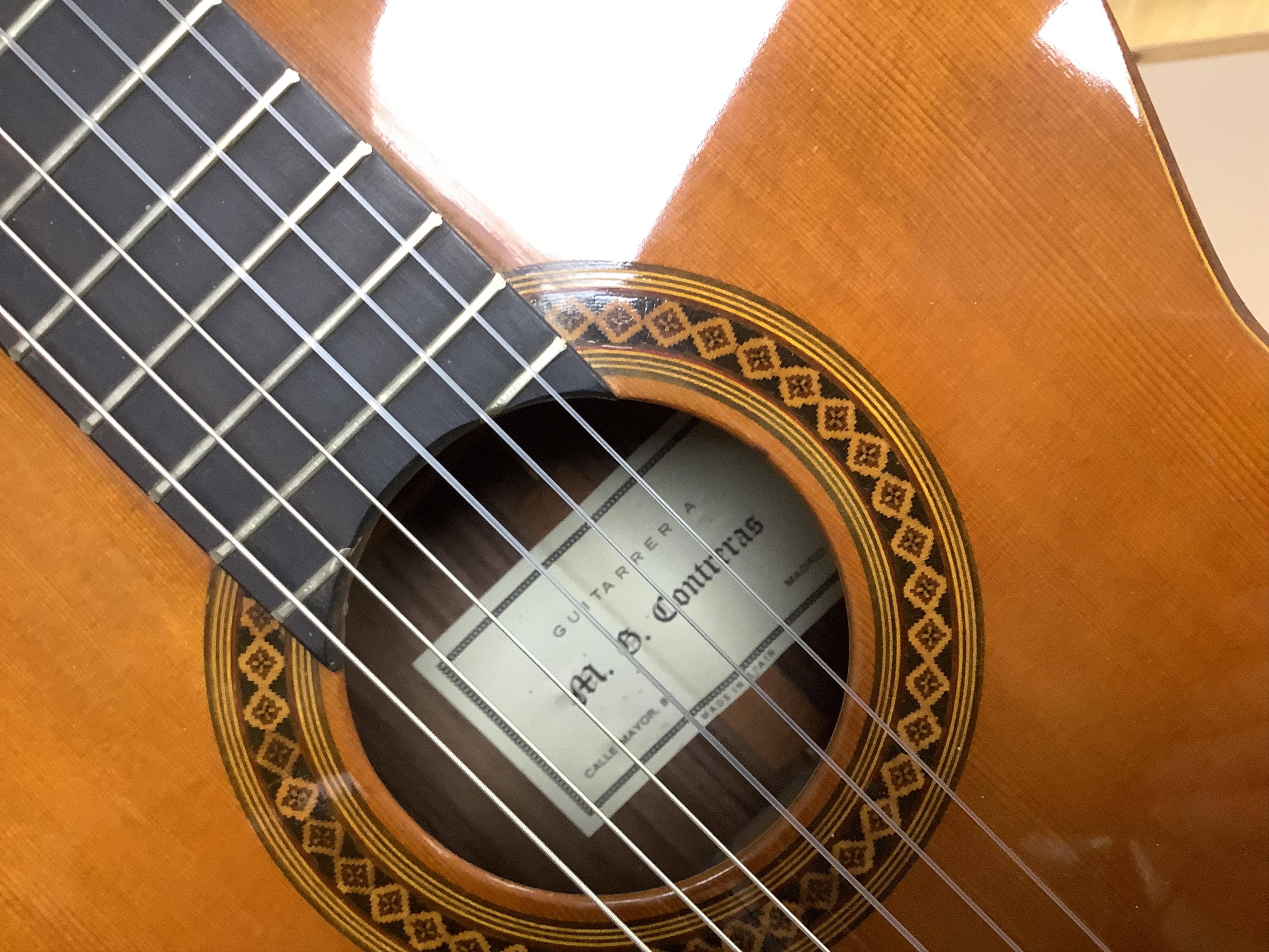A Spanish Manuel Contreras classical guitar, with cedar front, Indian rosewood back sides and ebony fingerboard, with makers label inside body; M.G. Contreras, Madrid, back 49cm